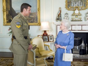 Queen Elizabeth II greets Australian SAS Corporal Ben Roberts-Smith (left), who was recently awarded the Victoria Cross for Australia, during an audience at Buckingham Palace in London Nov. 15, 2011.