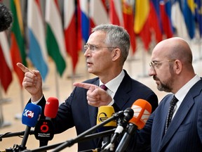 NATO Secretary General Jens Stoltenberg (left) and European Council President Charles Michel (right) talk to the media as they arrive for a European Council Summit, at the EU headquarters in Brussels, on June 29, 2023.