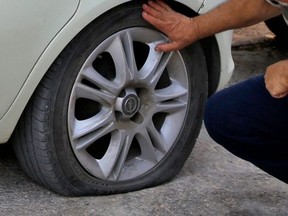 A slashed tire on a car is pictured in a file photo.