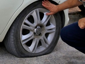 A slashed tire on a car is pictured in a file photo.