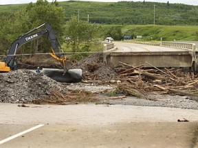Some of the damaged caused by flooding, where the Sheep River has created a new channel leaving the communities of Black Diamond and Turner Valley without a road to connect the two. Workers were trying to get the situation under control on June 24. 2013.