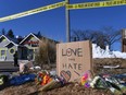 Bouquets of flowers and a sign reading "Love Over Hate" are left near Club Q, an LGBTQ nightclub in Colorado Springs, Colorado, on November 20, 2022.