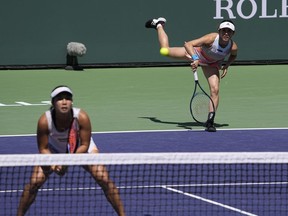 FILE - Miyu Kato, of Japan, right, serves behind her partner Aldila Sutjiadi, of Indonesia, as they play against Beatriz Haddad Maia, of Brazil, and Laura Siegemund, of Germany, in a doubles semifinal match at the BNP Paribas Open tennis tournament Friday, March 17, 2023, in Indian Wells, Calif. French Open doubles player Miyu Kato and her partner Aldila Sutjiadi have been forced to forfeit a match when Kato accidentally hit a ball girl in the neck with a ball after a point during their match against Marie Bouzkova and Sara Sorribes Tormo on Sunday, June 4, 2023.