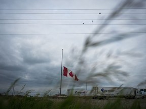 A Canadian flag flies at half-mast at a truck stop in Brandon, Man., on Friday, June 16, 2023, to honour the victims of a bus crash in Carberry, on the Trans-Canada Highway west of Winnipeg.