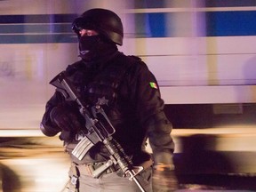 Mexican police stand guard on street during a security operation.