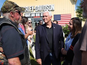 Former U.S. vice-president Mike Pence meets other riders before for the start of Joni Ernst's Roast and Ride on June 3, 2023 in Des Moines, Iowa.