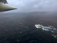 In this U.S. Coast Guard handout, a Coast Guard Air Station Elizabeth City, North Carolina HC-130 Hercules airplane flies over the French research vessel, L'Atalante approximately 900 miles East of Cape Cod during the search for the 21-foot submersible, Titan, June 21, 2023 over the Atlantic Ocean.