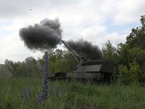 Ukrainian servicemen fire a 155mm self-propelled howitzer Panzerhaubitze 2000 towards Russian positions at a front line near Bakhmut, Donetsk region on June 15, 2023.
