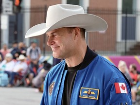 Canadian astronaut and parade marshal Jeremy Hansen leads the Calgary Stampede parade in downtown Calgary on Friday, July 7, 2023.