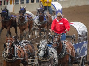 Kirk Sutherland comes at the finish in Heat 2 at the Rangeland Derby chuckwagon races at the Calgary Stampede on Sunday