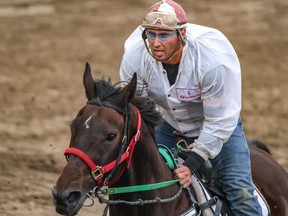 Outrider Rory Gervais in Heat 2 in the Rangeland Derby chuckwagon races at the Calgary Stampede on Monday