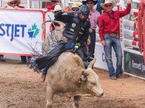 Jared Parsonage from Maple Creek, Saskatchewan wins the bull riding event on day six of the Calgary Stampede rodeo on Wednesday,