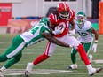 Calgary Stampeders Luther Hakunavanhu is tackled by Saskatchewan Roughriders defensive back Deontai Williams.