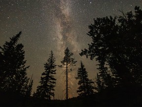 Smoke tints the Milky Way over the Lynx Creek valley south of Blairmore, Ab., on Wednesday, July 19, 2023.