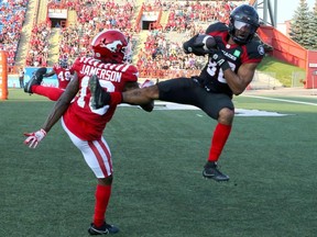 Ottawa's Nate Behar goes in the air for a TD in front of Stampeders' Natrell Jamerson.