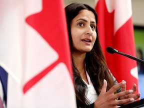 Minister of Seniors, Kamal Khera is framed by Canada flags as she announces funding for projects under the Age Well at Home initiative, during a press conference at the Westend Seniors Activity Centre, 9629 176 St., in Edmonton Monday July 17, 2023.