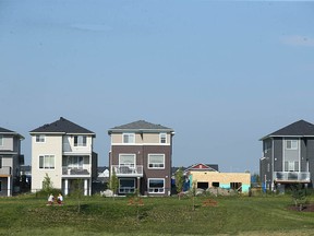 A house under construction is shown amongst completed homes in the far northeast community of Cornerstone in Calgary on Friday, July 21, 2023.