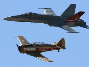 ATB Financial Alberta International Airshow,Lethbridge,Alberta.. A F-18 Hornet flies along with The Harvard during a demo at the show attended by 15,000 people.n/a ORG XMIT: p14oldnew050