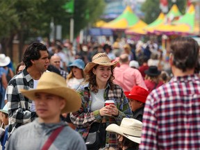 Crowds move through the Calgary Stampede grounds on Friday, July 14, 2023.