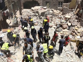 Rescuers search through the rubble of a collapsed five-story apartment building in Cairo, Egypt, Monday, July 17, 2023. A five-story apartment building collapsed Monday in the Egyptian capital of Cairo, leaving several people dead, authorities said, as rescuers at the scene searched through the rubble. Building collapses are common in Egypt, where shoddy construction and a lack of maintenance are widespread in shantytowns, poor city neighborhoods and rural areas.
