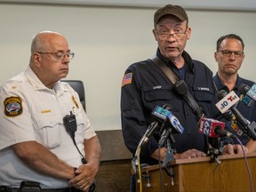 Gov. Josh Shapiro, right, looks on as Upper Makefield Fire Chief Tim Brewer speaks during a news media update at the Upper Makefield police headquarters in Makefield, Pa., Sunday, July 16, 2023, following fatal flash flooding on Saturday. Upper Makefield Chief of Police Mark Schmidt is at left.