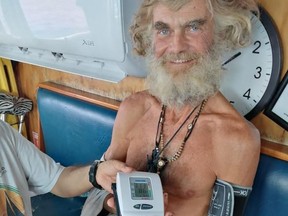 In this photo provided by Grupomar/Atun Tuny, Australian Tim Shaddock has is blood pressure taken after being rescued by a Mexican tuna boat in international waters, after being adrift with his dog for three months.
