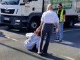 A climate activist is pulled off the road by her hair by a woman frustrated by the protest in Germany last week.