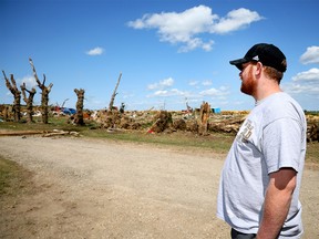 Travis Kellsey surveys the damage at his parents' property on Sunday, July 2, 2023, after a tornado destroyed property on Highway 2A between Didsbury and Carstairs the day before.