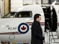 Prime Minister Justin Trudeau speaks to reporters at the Ottawa airport before getting on one of the Bombardier Challenger 650 business jet he uses for flying within Canada, January 29, 2023.