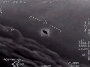 In this file photo taken on April 28, 2020 this video grab image courtesy of the U.S. Department of Defense shows part of an unclassified video taken by Navy pilots that have circulated for years showing interactions with "unidentified aerial phenomena".