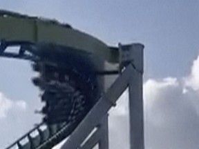 This image from video provided by Joey Mtnjunkie Puig shows a crack in a support pillar of the Fury 325 ride as a roller coaster passes by at North Carolina's Carowinds amusement park on Friday, June 30, 2023.