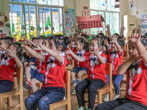 This file photo taken on May 11, 2020 shows children learning how to wash their hands in a classroom at a kindergarten in Yongzhou in China's central Hunan province.