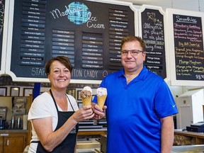 Meghan and Mark Tayfel hold cones of Keso, Barn Floor, and Haskap Berry, ice cream flavours they created, at their shop in Cochrane on Tuesday, July 18, 2023. MacKay's Cochrane Ice Cream is celebrating 75 years in 2023.