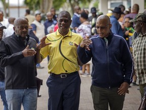 Then former African National Congress (ANC) treasurer general and now South African Deputy President, Paul Mashatile, center, walks out following a meeting of the ANC's national executive committee, in Johannesburg, South Africa, Friday Dec. 2, 2022. Mashatile's office said Tuesday, July 4, 2023 that a video showing armed police assaulting a man on a freeway until he lay motionless were part of the security team protecting Mashaile. There are no indications that Mashatile was present during the incident.