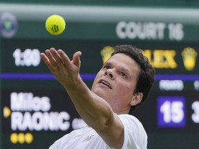 Canada's Milos Raonic serves to Austria's Dennis Novak during the men's singles match on day three of the Wimbledon tennis championships in London, Wednesday, July 5, 2023.