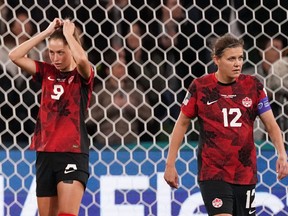 Canada’s Jordyn Huitema (left) and Christine Sinclair react after conceding the second goal during their loss to Australia.