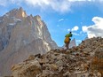 This picture taken on July 12, 2023, shows a Pakistani porter hiking on the trail between Askole and K2.