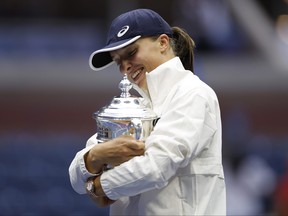 Iga Swiatek of Poland celebrates with the championship trophy after defeating Ons Jabeur of Tunisia during their Women's singles final of the 2022 US Open at USTA Billie Jean King National Tennis Center on September 10, 2022 in New York City.