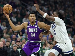 Giannis Antetokounmpo #34 of the Milwaukee Bucks drives to the basket against Naz Reid #11 of the Minnesota Timberwolves during the first half of a game at Fiserv Forum on December 30, 2022 in Milwaukee, Wisconsin.