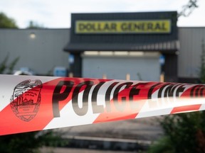 Crime scene tape stretches across the property of a Dollar General store where three people were shot and killed two days earlier on August 28, 2023 in Jacksonville, Florida.