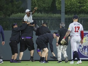 A fan yells to Ronald Acuna Jr. #13 of the Atlanta Braves after running onto the field and being apprehended by security during the game between the Colorado Rockies and the Atlanta Braves at Coors Field on August 28, 2023 in Denver, Colorado.