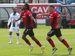 Cavalry Ali Musse (L) celebrates his first half goal a minute into the game and is joined by Fraser Aird during CPL soccer action between York United FC and Cavalry FC at ATCO Field at Spruce Meadows in Calgary on Sunday