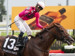 Patrick Husbands aboard Paramount Prince celebrates after winning the 164th running of the King’s Plate horse race in Toronto on Sunday, Aug. 20, 2023.