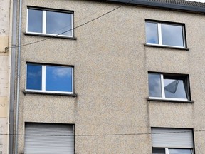 A photograph shows two windows (C) of the flat of a couple in Forbach, eastern France, on August 7, 2023, after French police said they had arrested a 55-year-old German national who is accused of holding his 53-year-old wife captive in a flat since 2011.