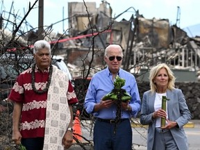U.S. President Joe Biden and U.S. First Lady Jill Biden participate in a blessing ceremony with the Lahaina elders at Moku'ula, following wildfires in Lahaina, Hawaii on Aug. 21, 2023. (Photo by Mandel Ngan/AFP via Getty Images)