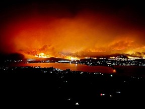 The Eagle Bluff wildfire is seen burning from Anarchist Mountain outside Osoyoos in a July 29 photo. An evacuation order for 700 properties was issued, but many people have since been allowed to return home.