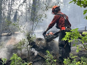 A firefighter on the ground on the Donnie Creek wildfire in northeastern B.C. Mandatory.
