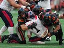 B.C. Lions defensive line takes down Montreal Alouettes quarterback Cody Fajardo on July 9. The Stampeders will have their hands full with the snarly defensive line this weekend.