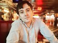 Ex-"Pharma Bro" Martin Shkreli sits in bar.