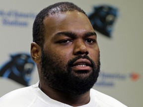 FILE - Carolina Panthers' Michael Oher speaks to the media during the first day of their NFL football offseason conditioning program in Charlotte, N.C., April 20, 2015. Oher, the former NFL tackle known for the movie "The Blind Side," filed a petition Monday, Aug. 14, 2023, in a Tennessee probate court accusing Sean and Leigh Anne Tuohy of lying to him by having him sign papers making them his conservators rather than his adoptive parents nearly two decades ago.